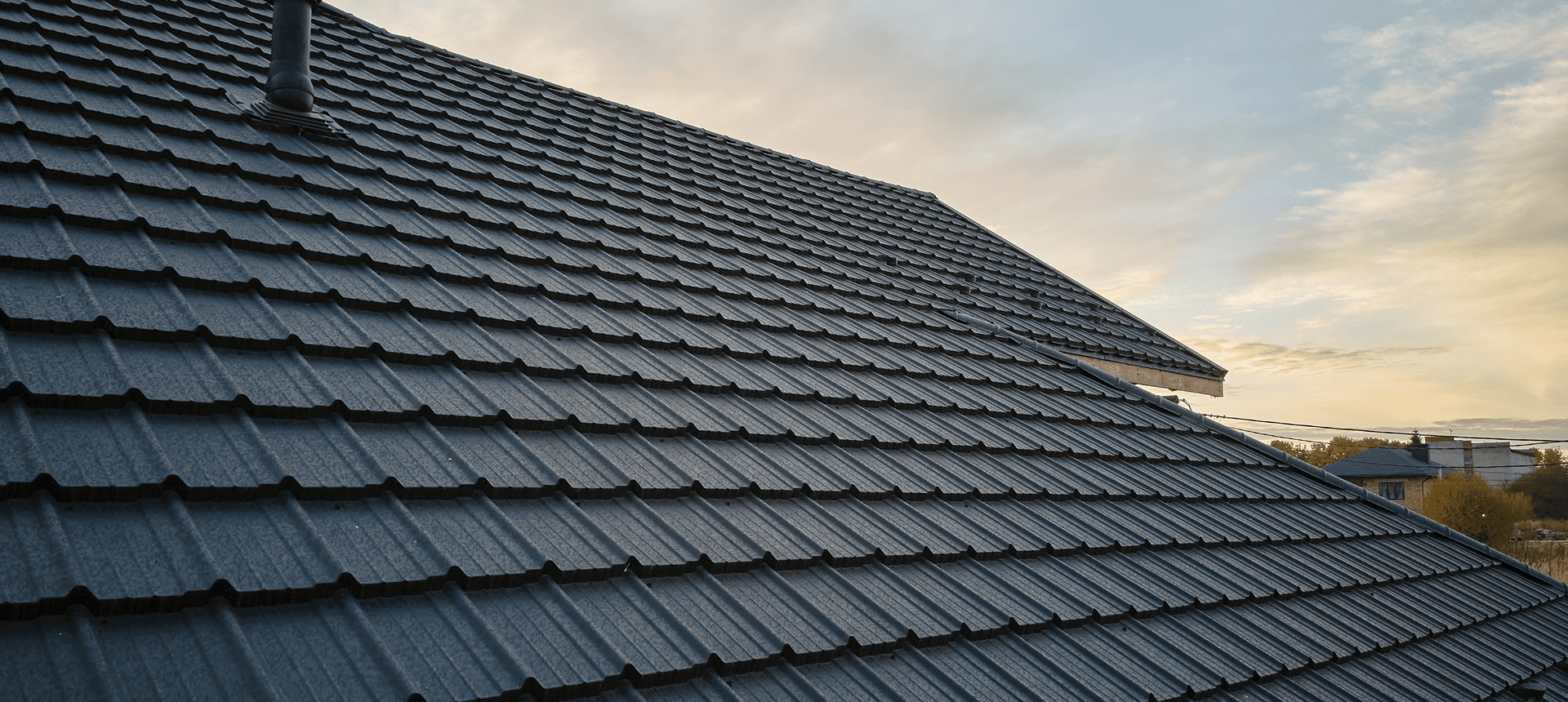 Close-up of tiled roof under sky