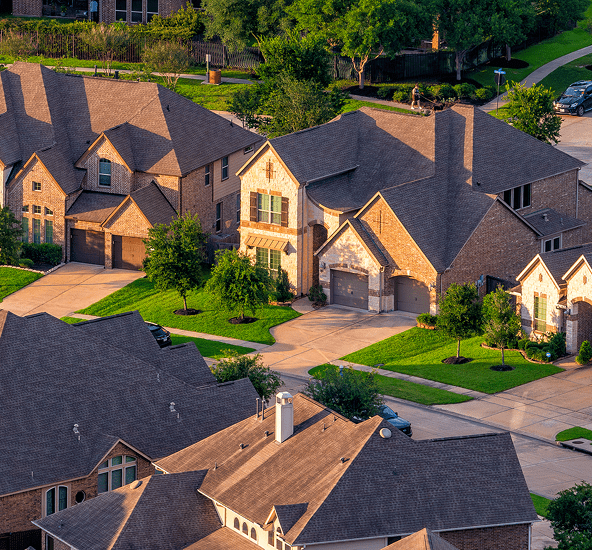Row of houses with driveways and trees